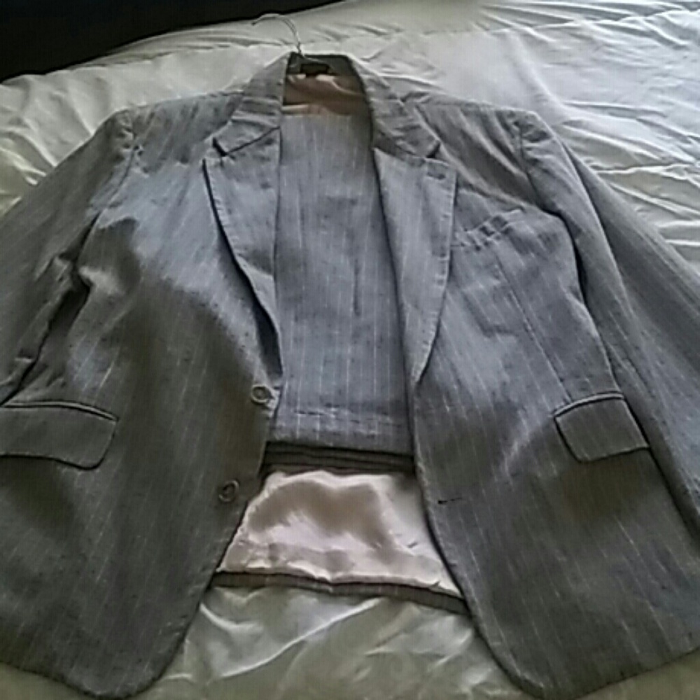 A two piece beige or tan pinstripe suit.